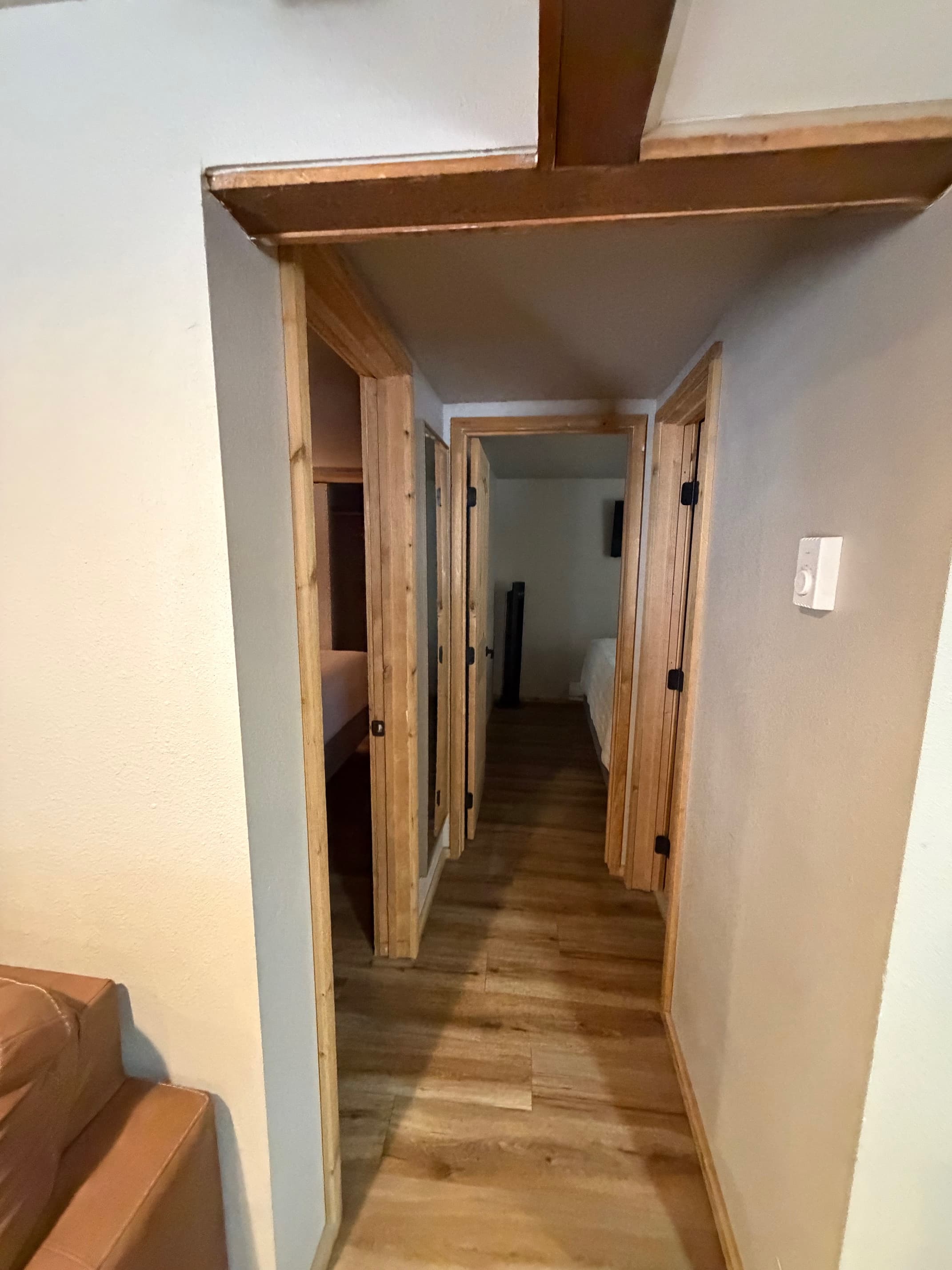 Hallway leading to the bathroom and two bedrooms.