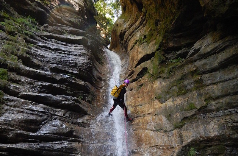 canyoning near a waterfall